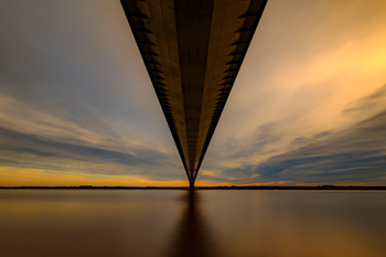 bridge at sunset view from underneath across water